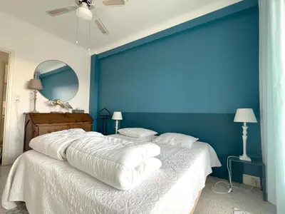 a bedroom with a blue wall and a large bed at Terrace and view on all Nice city in Nice
