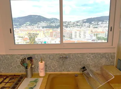 a kitchen with a window with a view of a city at Terrace and view on all Nice city in Nice