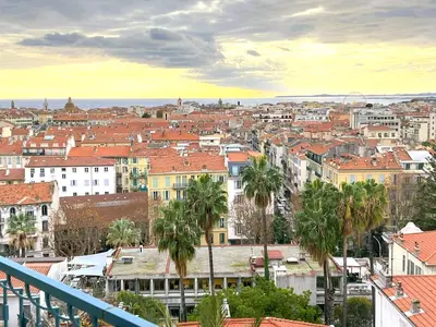 a view of a city with palm trees and buildings at Terrace and view on all Nice city in Nice