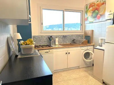 a kitchen with a sink and a washing machine at Terrace and view on all Nice city in Nice