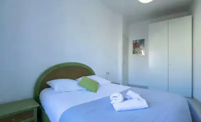 a bedroom with a white bed with towels on it at Place Grimaldi, close to beach and restaurants, with balcony in Nice