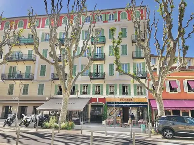 a large building on a city street with trees at Place Grimaldi, close to beach and restaurants, with balcony in Nice
