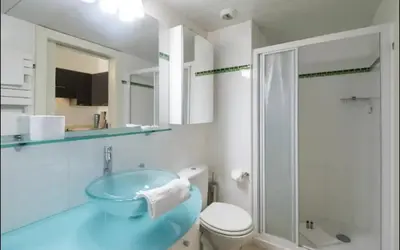 a bathroom with a blue sink and a toilet at Place Grimaldi, close to beach and restaurants, with balcony in Nice