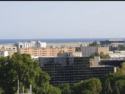 a view of a city with tall buildings at Grand Appartement 5 chambres, 5 télévision , 95 m2, vue mer, tramway sur place, gare train 2 min, aéroport 5 min , Large Apartment 5 bedrooms, 5 televisions, 95 m2, sea view, tram on site, train station 2 mins, airport 5 mins in Nice
