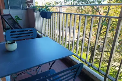 a blue table and two chairs on a balcony at 2-rooms apartment with Wifi and balcony in Nice