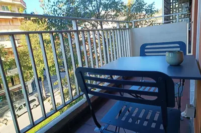a blue table and chair on a balcony at 2-rooms apartment with Wifi and balcony in Nice