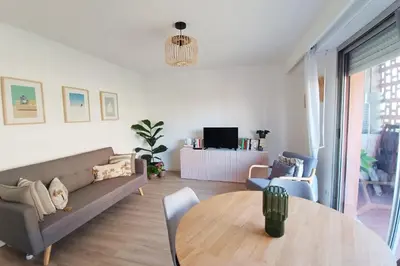 a living room with a couch and a table at 2-rooms apartment with Wifi and balcony in Nice