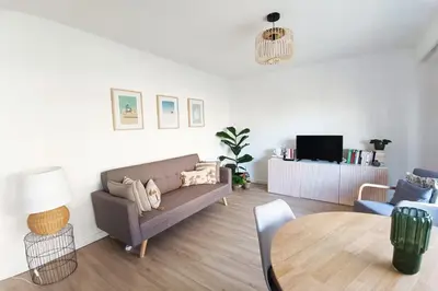 a living room with a couch and a table at 2-rooms apartment with Wifi and balcony in Nice