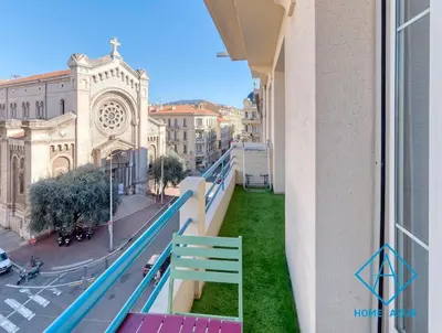 a balcony with a view of a church at Golden Square in Nice