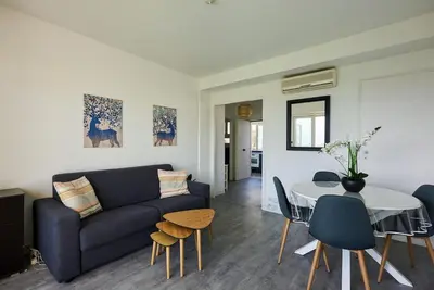 a living room with a couch and a table at Nice Excepetional view in Nice