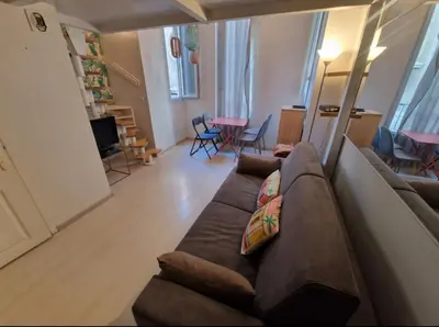 a living room with a brown couch and chairs at Carré d'Or Star Loft in Nice