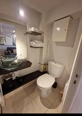 a bathroom with a toilet and a glass sink at Carré d'Or Star Loft in Nice