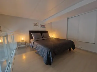 a bedroom with a large bed and a balcony at Carré d'Or Star Loft in Nice