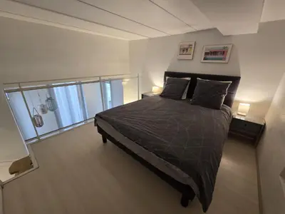a bedroom with a bed and a wooden floor at Carré d'Or Star Loft in Nice