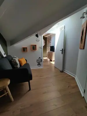 a living room with a couch and a hallway at Charming flat - Nice port in Nice