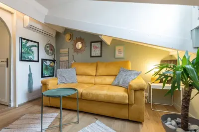 a living room with a couch and a table at Charming flat - Nice port in Nice