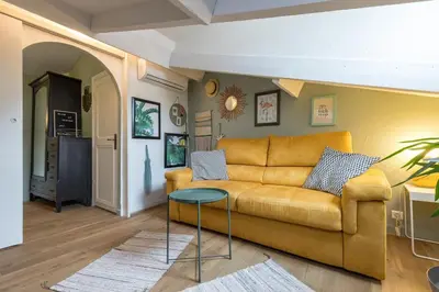 a living room with a couch and a table at Charming flat - Nice port in Nice