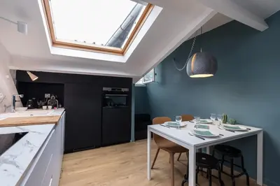a kitchen with a white table with chairs and a window at Charming flat - Nice port in Nice