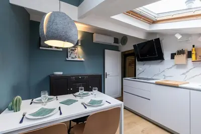 a kitchen with a white table with chairs and a counter at Charming flat - Nice port in Nice
