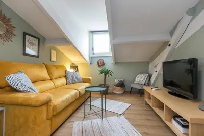 a living room with a couch and a tv at Charming flat - Nice port in Nice