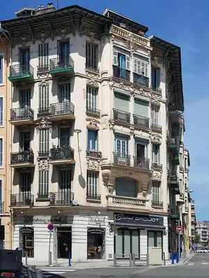 a tall building with balconies on a city street at Charming flat - Nice port in Nice