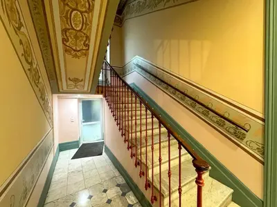 a hallway with a staircase in a building at Syrah - Cozy Apartment in Nice