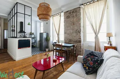 a bedroom with a blue bed and a large window at WeHost Phillibert - L'Ecrin Vintage So NICE in Nice