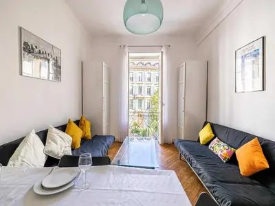 a living room with a couch and a glass table at Superb 2 room apartment in the heart of Nice in Nice