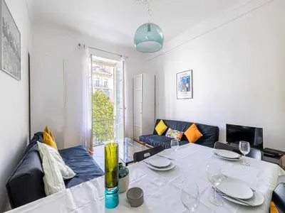 a living room with a table and a couch at Superb 2 room apartment in the heart of Nice in Nice