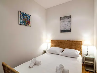 a bedroom with a bed with two pillows on it at Superb 2 room apartment in the heart of Nice in Nice