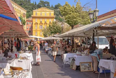 a group of people walking through a market with tables at Studio au cœur de Nice lumineux in Nice