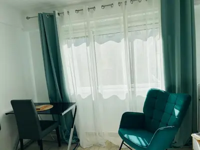a room with a window with a chair and a table at Superbe appartement Port de Nice Lumineux,Clim , Parking in Nice