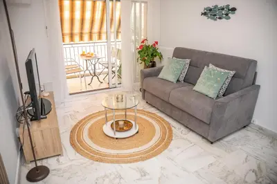 a living room with a couch and a table at Superbe appartement Port de Nice Lumineux,Clim , Parking in Nice