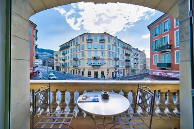 a view from a balcony with a table and chairs at Port of Nice - Scooters Included in Nice