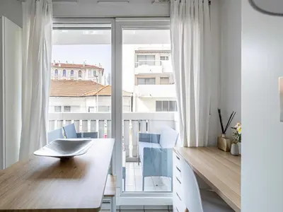 a room with a desk and a large window at Studio with balcony & pool -Heart of Nice in Nice