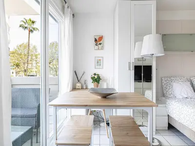 a living room with a table and a bed at Studio with balcony & pool -Heart of Nice in Nice