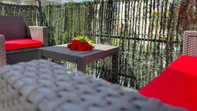 a table with a red flower on top of it at ⁂ Studio cosy 3 min de la plage terrasse clim in Nice