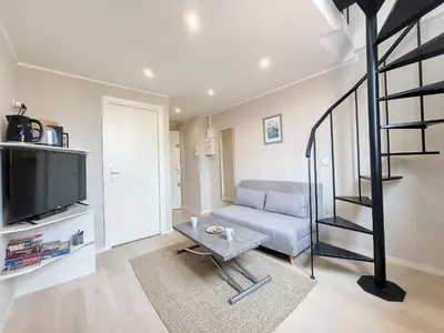 a living room with a couch and a television at Nestor&Jeeves - VIEUX NICE DUPLEX - Studio - Central in Nice