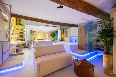 a living room with a white couch and blue lighting at Studio29 in Nice