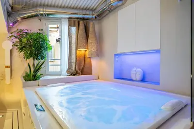 a large blue tub in a room with a window at Studio29 in Nice