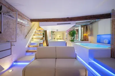 a room with a bathtub and stairs with a bench at Studio29 in Nice