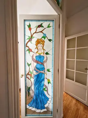 a stained glass door with a woman in a blue dress at Cosy appartement in Nice city center in Nice