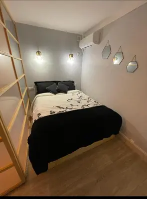 a bedroom with a bed in a room with a ladder at Villa Elisabeth in Nice