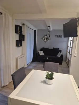 a living room with a table and a couch at Villa Elisabeth in Nice
