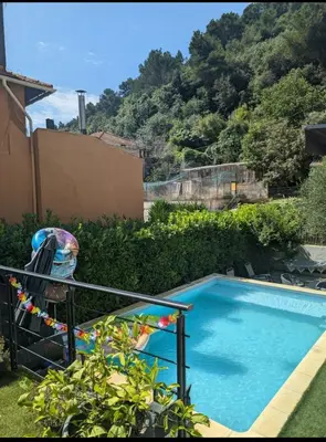 a small blue swimming pool in a yard at Villa Elisabeth in Nice