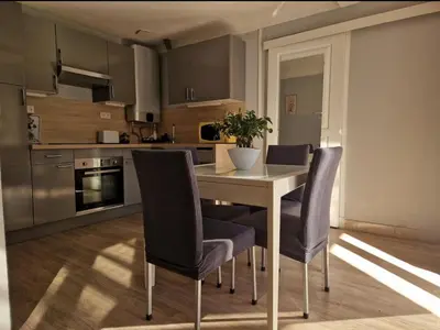 a kitchen with a table and chairs in a room at Villa Elisabeth in Nice