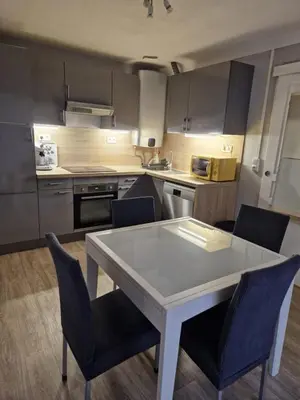 a kitchen with a white table and chairs at Villa Elisabeth in Nice