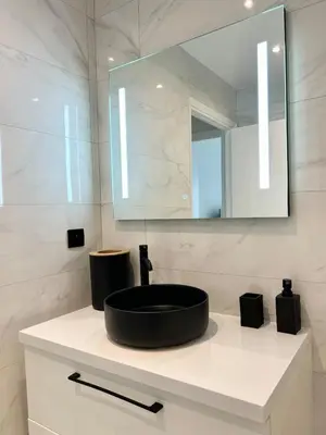a bathroom with a black sink and a mirror at Le Grand Soleil in Nice