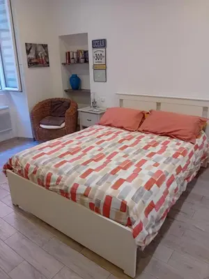 a bedroom with a bed and a chair in it at Nice Studio Old Town Sea Side in Nice