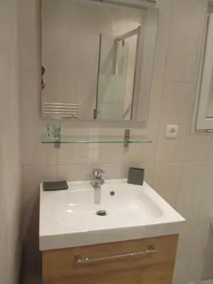 a bathroom with a white sink and a mirror at Nice Studio Old Town Sea Side in Nice